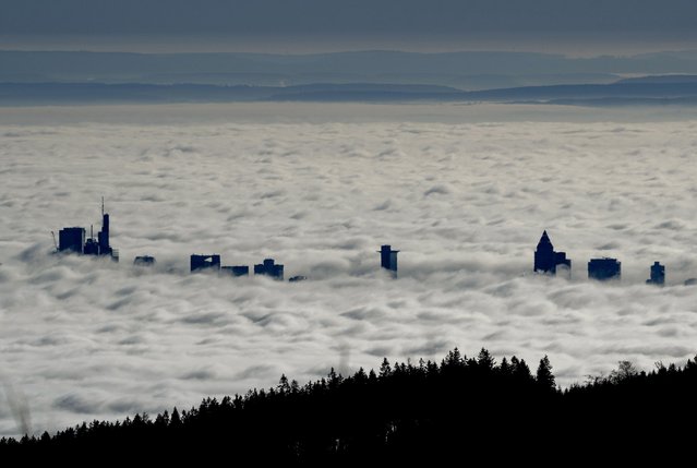 The buildings of the banking district come out of the thick fog over Frankfurt, Germany, Friday, December 27, 2024. (Photo by Michael Probst/AP Photo)