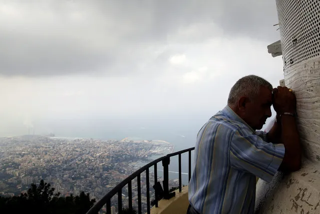 A pilgrim prays at the feet of a shrine to the Virgin Mary in Harissa, near Beirut, Lebanon, Lebanon, Friday, September 6, 2019. The pilgrimage site with the statue of Virgin Mary is about 15 tons of bronze, painted in white and is also known as “Our Lady of Lebanon”. (Photo by Amr Nabil)/AP Photo