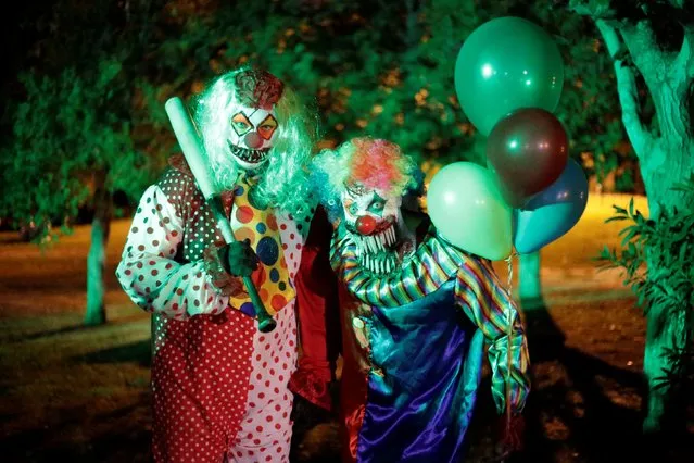 Men dressed as clowns pose for a photo during a Halloween party in Ciudad Juarez, Mexico, October 27, 2017. (Photo by Jose Luis Gonzalez/Reuters)