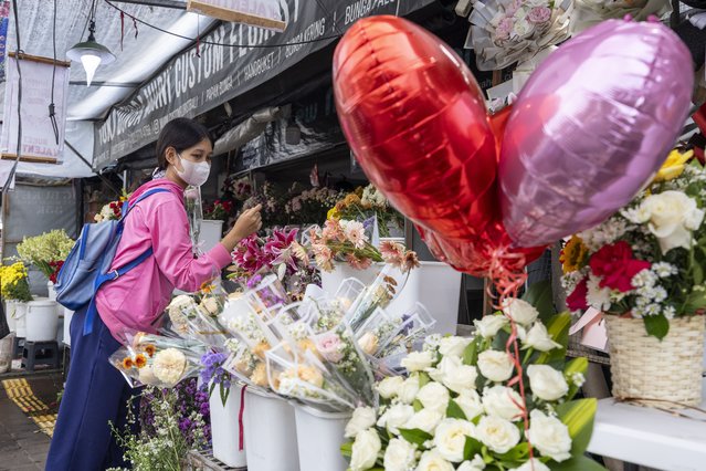 A person shops for Valentine's day gifts at a shop in Denpasar, Bali, Indonesia, 14 February 2025. Valentine's Day is celebrated annually on 14 February when lovers express their affection for each other with greetings and gifts. (Photo by Made Nagi/EPA/EFE)