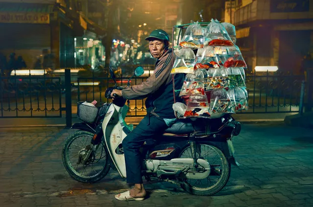 Hanoi Bikes: Jon Enoch, UK; Shortlist, Portraiture. “Delivery drivers on the streets of Hanoi, Vietnam, use their amazing balance skills to deliver goods to shops and vendors across the city. Some riders sell directly from their bikes. New legislation plans to ban motorbikes from the city by 2030 in a bid to improve air quality and reduce congestion”. (Photo by Jon Enoch/Sony World Photography Awards 2020)