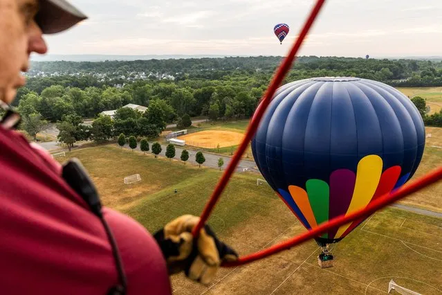 Hot air balloons land during the 39th annual New Jersey Lottery Festival of Ballooning at Solberg Airport Friday, July 29, 2022, in Readington, N.J. (Photo by Julia Nikhinson/AP Photo)