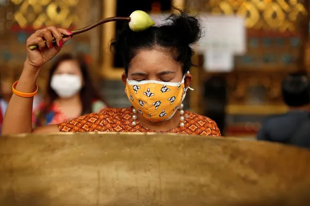 A woman wearing a protective face mask visits the Grand Palace, as it reopens after months of being closed, as the Thai government eases isolation measures, amid the spread of the coronavirus disease (COVID-19) in Bangkok, Thailand, June 7, 2020. (Photo by Jorge Silva/Reuters)