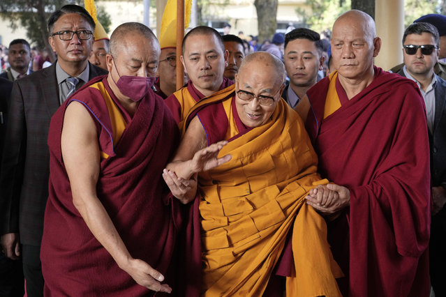 Tibetan spiritual leader the Dalai Lama, in yellow robe, arrives to give a sermon on the 15th day of the Tibetan New Year at the Tsuglakhang temple in Dharamshala, India, Friday, March 14, 2025. (Photo by Ashwini Bhatia/AP Photo)