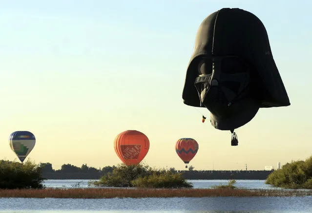 A hot air balloon in the shape of Darth Vader flies with others during the Hot Air Balloons Festival in Leon, Mexico, November 16, 2009. (Photo by Mario Armas/Reuters)