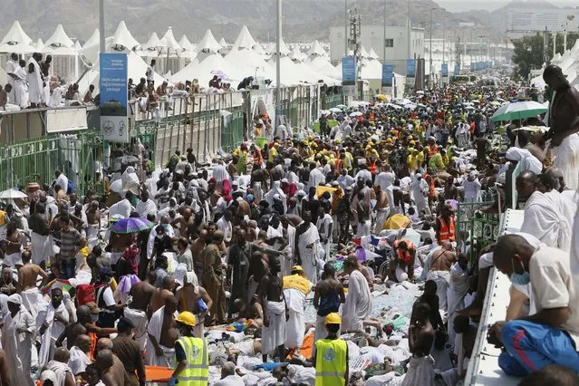 Muslim pilgrims and rescuers gather around people who were crushed by overcrowding in Mina, Saudi Arabia during the annual hajj pilgrimage on Thursday, September 24, 2015. (Photo by AP Photo)