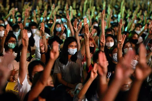 Pro-democracy protesters do a three-fingered salute as they attend a rally to demand the government to resign, to dissolve the parliament and to hold new elections under a revised constitution, at Thammasat University's Rangsit campus outside of Bangkok, Thailand on August 10, 2020. (Photo by Chalinee Thirasupa/Reuters)