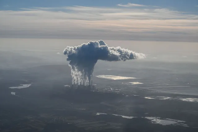 Steam and smoke rises from the Belchatow Coal Powered Station, as seen from an aircraft on October 12, 2022 in Belchatow, Poland. The Belchatow coal-powered station, with an output of 5,472 megawatts, is the world's largest lignite coal-fired power station. As Europe's most coal-dependent country, Poland relies on the power station to produce 70% of its power. (Photo by Omar Marques/Getty Images)