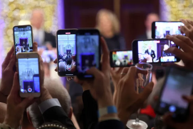 Audience members record on their phones as U.S. President Joe Biden and first lady Jill Biden host a Hanukkah holiday reception at the White House in Washington, U.S., December 19, 2022. (Photo by Leah Millis/Reuters)