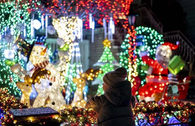 Christmas lights and ornaments are viewed outside of a home in Dyker Heights neighborhood of Brooklyn borough of New York, United States on December 6, 2022. Dyker Heights is one of the most culturally and ethnically diverse areas in the nation, hosts numerous neighborhoods where Christmas tree lights have become a significant attraction with hundreds of cars and pedestrians arriving daily to view the homes. The Dyker Heights neighborhood has become the most popular area for Christmas lights viewing. (Photo by Fatih Aktas/Anadolu Agency via Getty Images)