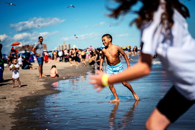 Kids enjoy the beach on Memorial Day at Coney Island Beach in the Brooklyn borough of New York City, U.S., May 26, 2025. (Photo by Angelina Katsanis/Reuters)