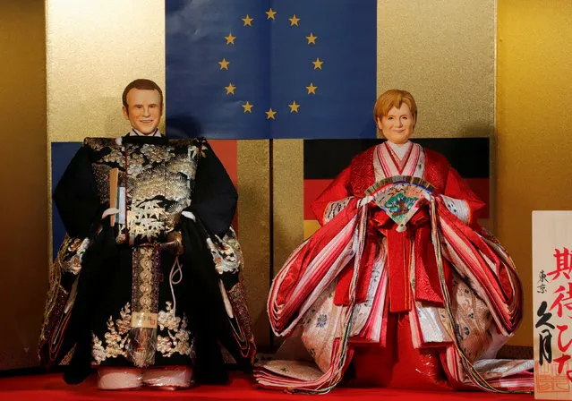 Japanese ornamental “hina” dolls made in the likeness of French President Emmanuel Macron (L) and German Chancellor Angela Merkel are displayed during its unveiling at Kyugetsu traditional doll shop in Tokyo, Japan January 25, 2018. The dolls are displayed ahead of “Girls Day”, a holiday meant to celebrate the health and happiness of girls. (Photo by Kim Kyung-Hoon/Reuters)