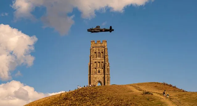 A Lancaster bomber flies over Glastonbury Tor in Somerset on August 29 2022 The plane had been flying over Willersey Fete, Gloucestershire, today in honour of Squadron Leader Henry Maudslay a pilot with No. 617 Squadron of the Royal Air Force (RAF). Maudslay was killed in action while taking part in Operation Chastise, popularly known as the “Dam Busters” raid. (Photo by Michelle Cowbourne/South West News Service)