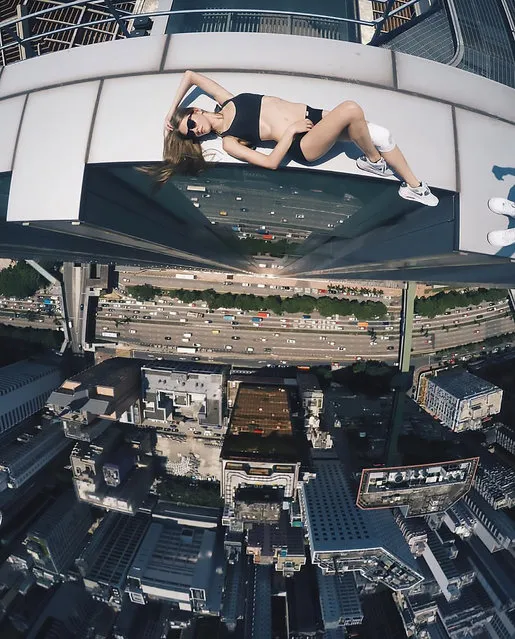 An astonishing set of snaps of a thrill-seeker's sky-high catwalk show on the edge of some of the world's tallest buildings has turned her into a social media sensation. Daredevil Angelina Nikolau, 23, from Russia, has spent weeks travelling around China and Hong Kong posing for jaw-dropping skyscraper selfies hundreds of feet above the ground. Her vertigo inducing results – uploaded to Instagram – have made her an instant star on the internet. Angelina is described by Russian media as “self-taught photographer, adventurer and roofer from Moscow”. Roofing – also known as rooftopping – is where people get as close as possible to the edge of a skyscraper's highest point to take selfies. (Photo by Kirill Oreshkin/CEN)