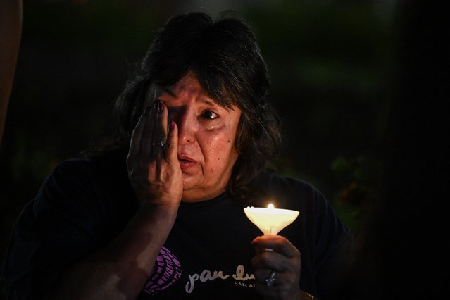A woman wipes away tears during a vigil for the victims of the floods over Fourth of July weekend, at Travis Park, in San Antonio, Texas, on July 7, 2025. The death toll from catastrophic flooding in Texas rose to more than 100 on July 7, as rescuers continued their grim search for people swept away by torrents of water. Among the dead were at least 27 girls and counselors who were staying at a youth summer camp on a river when disaster struck over the Fourth of July holiday weekend. (Photo by Ronaldo Schemidt/AFP Photo)