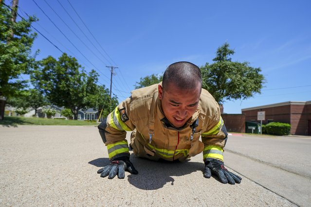 Mansfield Fire Department Station 1 firefighter Anthony Nguyen works out in fire gear under triple-digit weather Wednesday, July 30, 2025, in Mansfield, Texas. (Photo by Julio Cortez/AP Photo)