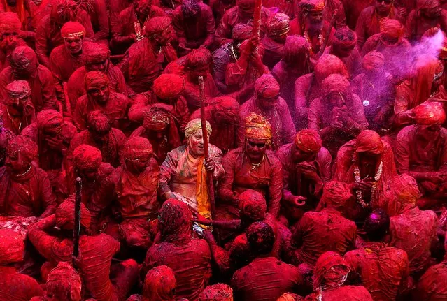 Devotees smeared with colors sing at the Nandagram temple, on March 22, 2013. (Photo by Manish Swarup/Associated Press)