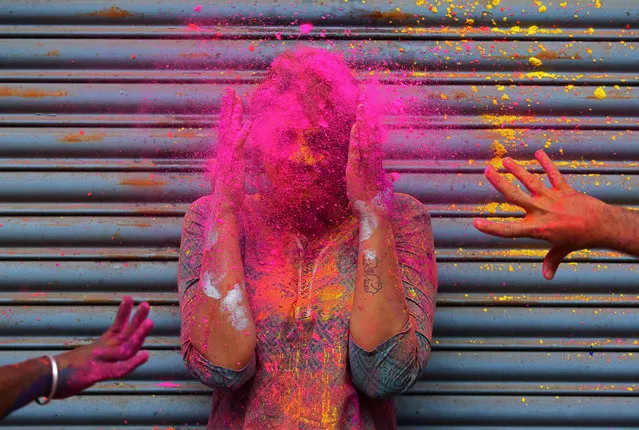 A woman reacts as coloured powder is thrown on her face during Holi celebrations in Chennai, India on March 2, 2018. (Photo by P. Ravikumar/Reuters)