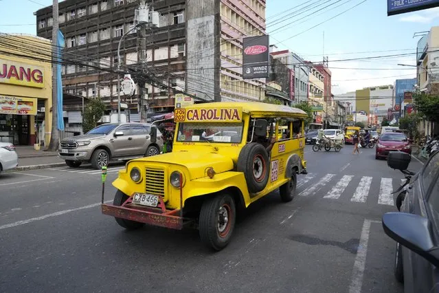A vintage passenger jeepney passes by a road just outside what used to be America's largest overseas naval base at Olongapo city, Zambales province, northwest of Manila, Philippines on Monday February 6, 2023. (Photo by Aaron Favila/AP Photo)
