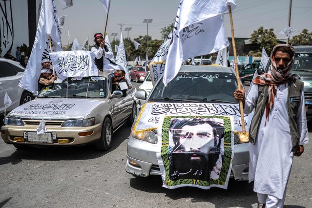 A car with a poster of late Taliban leader Mullah Omar is seen during the celebrations marking the fourth anniversary of the Taliban takeover of Afghanistan at the Massoud Square in Kabul on August 15, 2025. Afghanistan's Taliban authorities marked the fourth anniversary of their takeover on August 15, buoyed by Russia's first official recognition of their government, a step they hope other countries will follow. (Photo by Wakil Kohsar/AFP Photo)