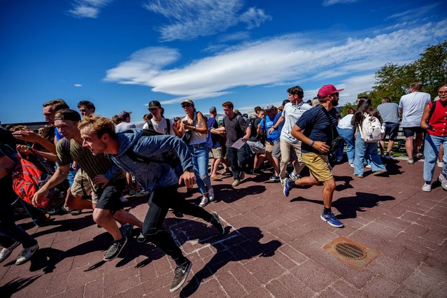 People run after a shot was fired at U.S. right-wing activist and commentator Charlie Kirk during a Utah Valley University speaking event in Orem, Utah, U.S. on September 10, 2025. (Photo by Trent Nelson/The Salt Lake Tribune via Reuters)