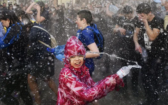 Ukrainians pour water on each other on a street in downtown of the West-Ukrainian city of Lviv, Ukraine, 09 April 2018. The custom of pouring water is an ancient spring cleansing rite that takes place on the first Monday after Orthodox Easter. (Photo by Markiian Lyseiko/EPA/EFE)