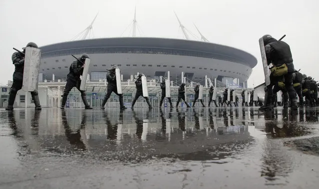 Riot police practice in front of the new soccer stadium “Saint Petersburg” which will host some 2018 World Cup matches in St.Petersburg, Russia, Tuesday, April 17, 2018. (Photo by Dmitri Lovetsky/AP Photo)