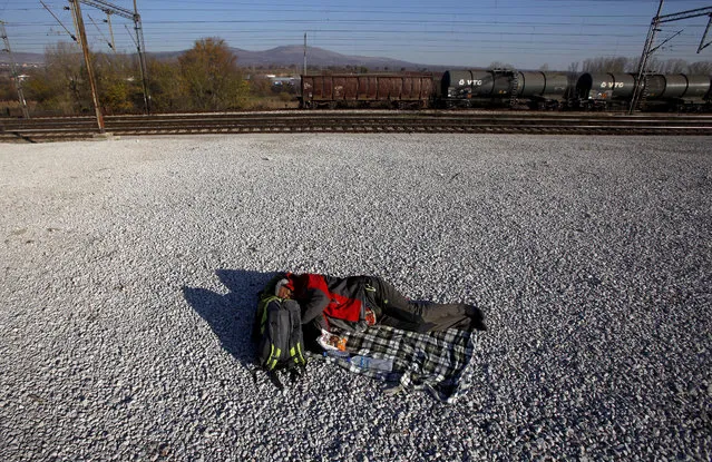 A migrant who was not allowed to cross into Serbia, sleeps on the ground near the village of Tabanovce, in northern Macedonia, Thursday, November 19, 2015. Four nations along Europe's Balkan refugee corridor shut their borders Thursday to those not coming from war-torn countries such as Syria, Afghanistan or Iraq, leaving thousands of others seeking a better life in Europe stranded at border crossings. (Photo by Boris Grdanoski/AP Photo)
