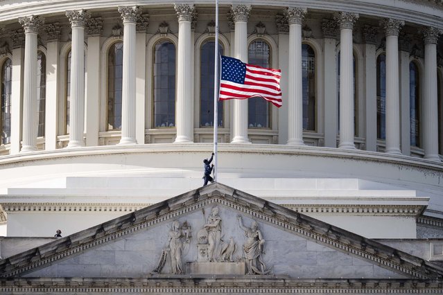A worker lowers the American flag to half-staff at the US Capitol on Tuesday, November 4. Former Vice President Dick Cheney died Monday at the age of 84. (Photo by Tom Williams/CQ-Roll Call, Inc/Getty Images)