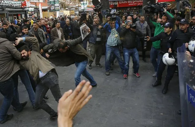 Police use tear-inducing agent against demonstrators during a protest over the arrest of journalists Can Dundar and Erdem Gul in Ankara, Turkey, November 27, 2015. People protested on Friday over the arrest of two prominent journalists on charges of espionage and terrorist propaganda, a case that has revived long-standing criticism of Turkey's record on press freedom under President Tayyip Erdogan. (Photo by Umit Bektas/Reuters)