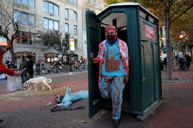 A man in costume exits a portable restroom before participating in the Greenwich Village Halloween Parade in Manhattan, New York, U.S., October 31, 2016. (Photo by Andrew Kelly/Reuters)