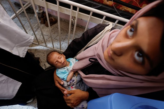 A Palestinian woman holds a child, as children receive vaccinations against polio, amid the Israel-Hamas conflict, at Nasser hospital in Khan Younis in the southern Gaza Strip, on August 31, 2024. (Photo by /Mohammed SalemReuters)