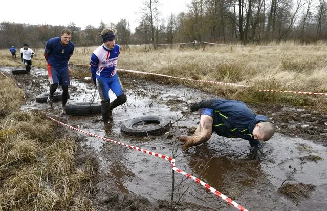 People take part in the "Bison Race" winter extreme run competition in Zhodino, Belarus, December 5, 2015. (Photo by Vasily Fedosenko/Reuters)