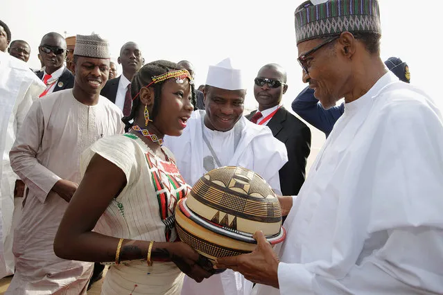 Nigeria's President Muhammadu Buhari receives a present during the commissioning of Kalambaina 500 Housing Estate project in Sokoto, Nigeria November 5, 2016. (Photo by Reuters/Stringer)