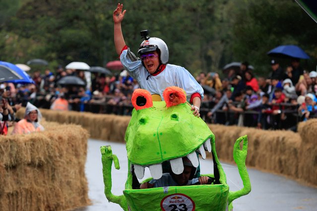 People are seen during the Red Bull Balineras Race in Bogota, Colombia on September 29, 2024. The Red Bull Balineras Race is a one-of-a-kind competition where creativity meets adrenaline. Participants build their own motorless vehicles, called 'balineras,' and race them down a steep track full of twists and turns, relying only on gravity to guide them. It's been twelve years since Bogotá buzzed with the thrill and inventive spirit of these fearless teams, bringing a sense of community and excitement to the streets. (Photo by Juancho Torres/Anadolu via Getty Images)