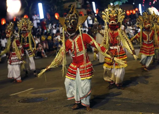 Traditional dancers perform at Navam Perahera, a Buddhist pageant of elephants, dancers and drummers, in Colombo February 3, 2015. (Photo by Dinuka Liyanawatte/Reuters)