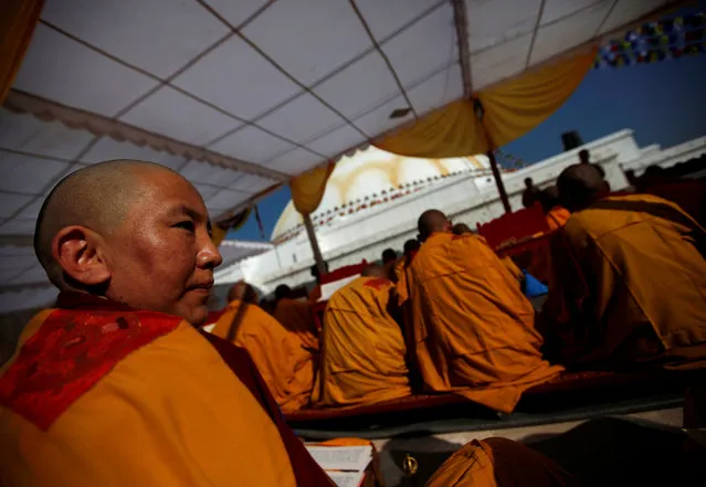 A Buddhist nun (L) takes part in prayers to purify the Boudhanath stupa ahead of its opening on November 22, after it was renovated following last year's earthquake in Kathmandu, Nepal November 18, 2016. (Photo by Navesh Chitrakar/Reuters)