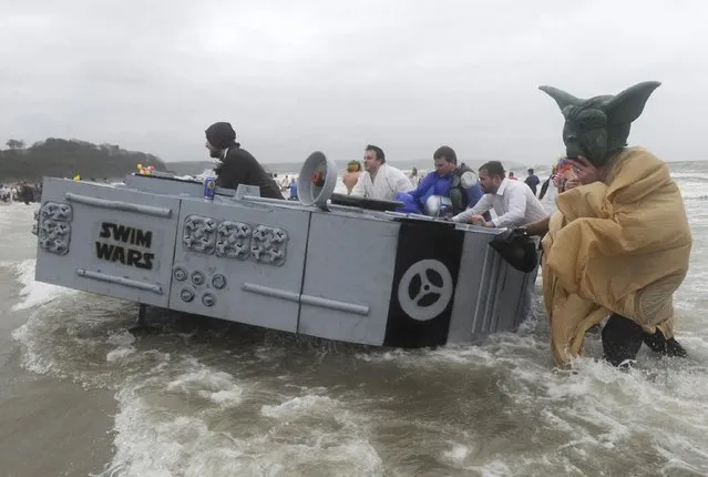 Swimmers in fancy dress participate in the New Year's Day swim at Saundersfoot in south Wales, Britain January 1, 2016. (Photo by Rebecca Naden/Reuters)