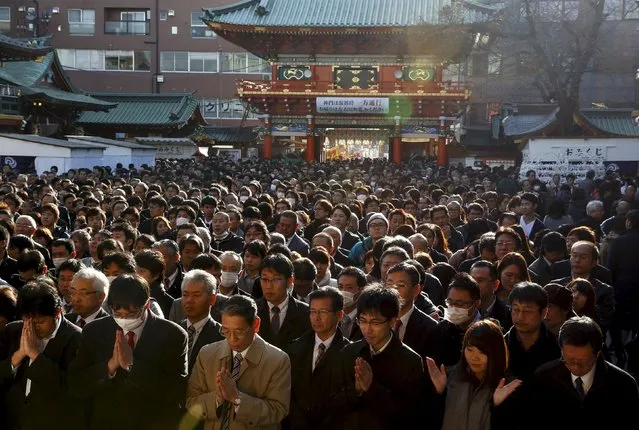 People pray at the start of the new business year at Kanda Myojin Shrine in Tokyo, Japan, January 4, 2016. Several thousand company representatives traditionally visit the shrine on the first day of business in the new year to ask for luck and commercial fortune. (Photo by Thomas Peter/Reuters)