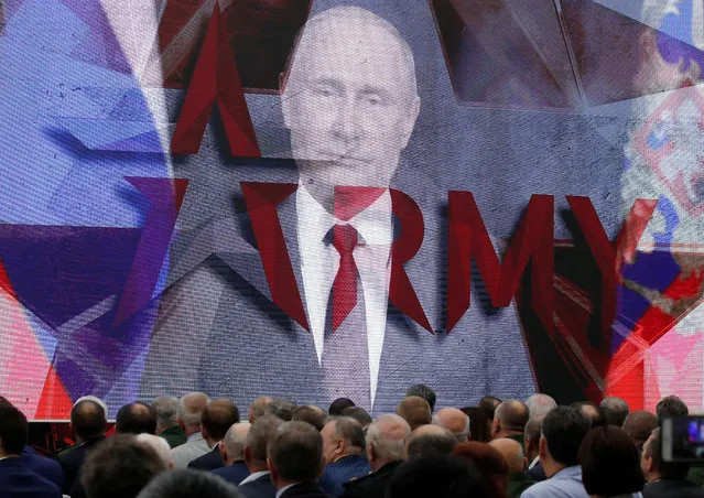 Russia's President Putin addresses participants via a video link during the opening of the forum “ARMY” in Moscow Region, Russia on August 21, 2018. (Photo by Maxim Shemetov/Reuters)