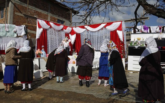 Bulgarian Muslim women look at the dowry during the wedding ceremony of Bulgarian Muslims Fikrie Bindzheva and Azim Liumankov in the village of Ribnovo, in the Rhodope Mountains, February 15, 2015. (Photo by Stoyan Nenov/Reuters)