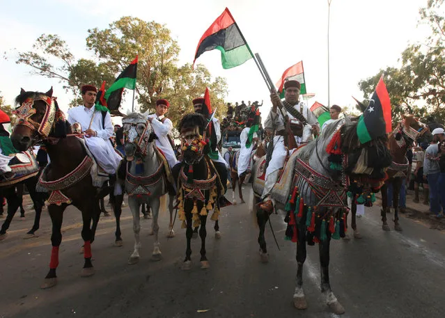 Libyan revolutionary fighters coming back from Sirte are welcomed at Al Guwarsha gate in Benghazi, Libya,  October 22, 2011. (Photo by Esam Al-Fetori/Reuters)