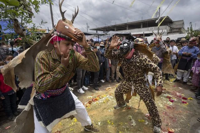 Indigenous dancers perform The Dance of the Deer during the Corpus Christi celebration in the Kaqchikel Indigenous town of Patzun, Guatemala, Sunday, June 19, 2022. (Photo by Moises Castillo/AP Photo)