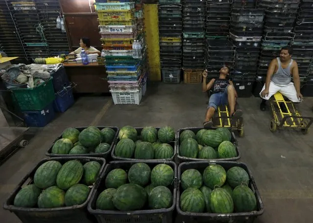 Workers take a break from unloading watermelon at a wholesale market in Kuala Lumpur, Malaysia, January 7, 2016. (Photo by Olivia Harris/Reuters)