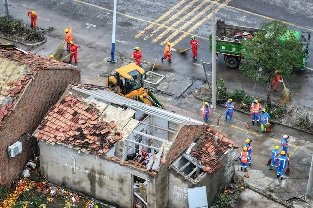 Workers clear debris after a tornado hit the city of Suqian, in China's eastern Jiangsu province on September 20, 2023. (Photo by AFP Photo/China Stringer Network)