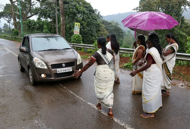 Hindu devotees stop a car to check if any women of menstruating age are headed towards the Sabarimala temple, at Nilakkal Base camp in Pathanamthitta district in the southern state of Kerala, October 16, 2018. (Photo by Sivaram V/Reuters)