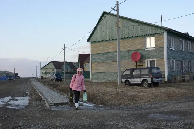 A woman walks along a street in Malokurilskoye settlement on the Island of Shikotan, one of four islands known as the Southern Kuriles in Russia and the Northern Territories in Japan, December 19, 2016. (Photo by Yuri Maltsev/Reuters)
