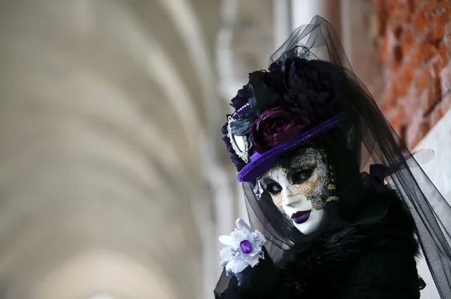 A masked reveller poses during the Venice Carnival, in Piazza San Marco January 30, 2016. (Photo by Alessandro Bianchi/Reuters)