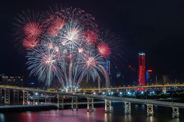 A firework display by United Kingdom's team light up the sky near the Macau Tower shorefront during the 31st Macau International Fireworks Contest, in Macau on October 11, 2023. (Photo by Eduardo Leal/AFP Photo)