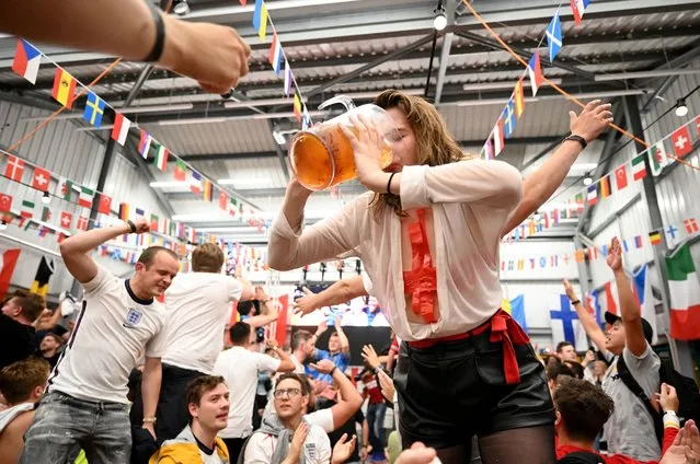 England fans celebrate as they watch a live broadcast of the semi-final match between England and Denmark at Hackney Bridge on July 07, 2021 in London, England. England has reached the semi-finals of the UEFA European Football Championship 2020 hoping to make the final for the first time in the history of the competition. (Photo by Leon Neal/Getty Images)